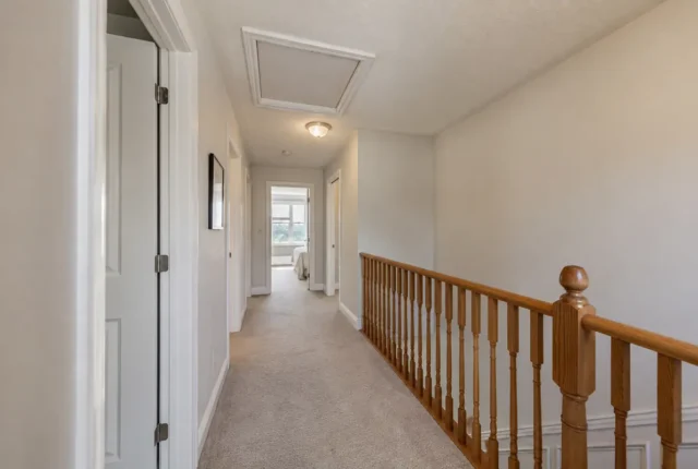Upstairs hallway with attic opening