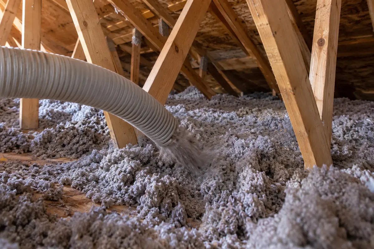 Blown-in insulation hose across attic floor
