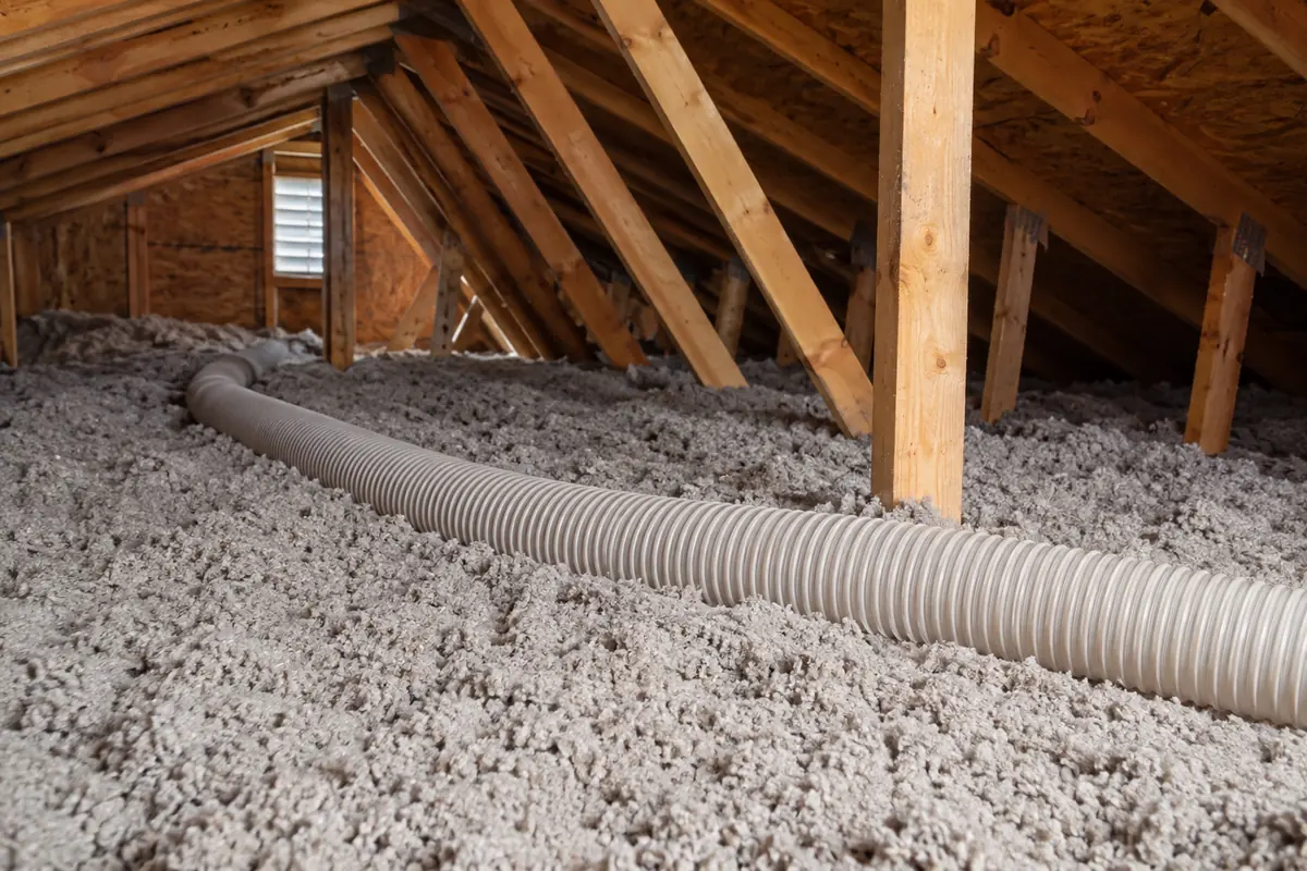 Loose-fill insulation beside attic framing